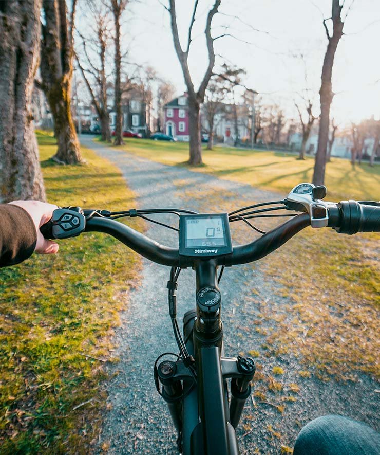 Person Riding Electric Bike on Path Person Riding Electric Bike on Path